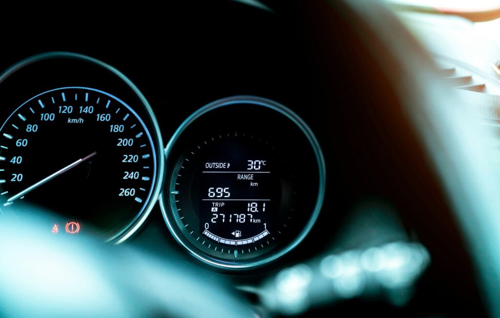 Closeup car fuel gauge dashboard panel. Gasoline indicator meter and speedometer. Fuel gauge show